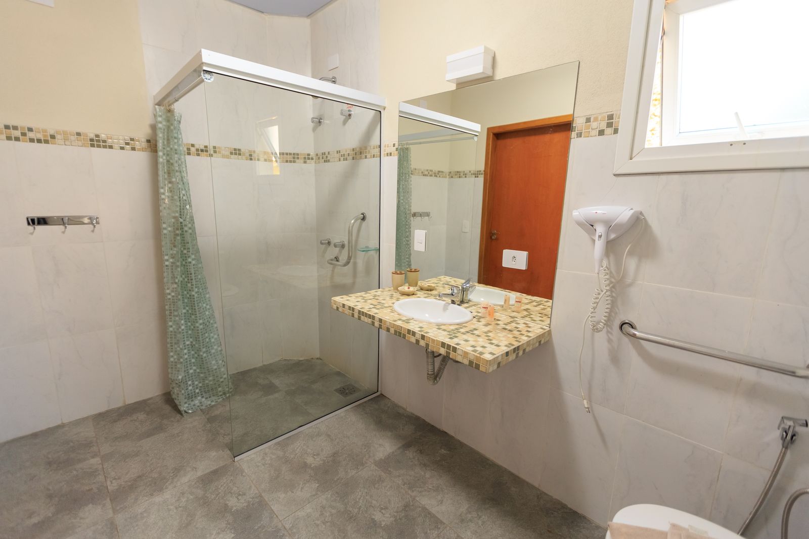 Barrierefreies Bad mit bodengleicher Dusche, Haltegriffen und unterfahrbarem Waschbecken